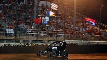 Tanner Thorson (Minden, Nev.) races under the checkered flag to win Friday night's USAC NOS Energy Drink National Midget feature at Jefferson County Speedway in Fairbury, Nebraska. (Lonnie Wheatley Photo) (Video Highlights from FloRacing.com)