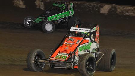 C.J. Leary (#77m) takes the high road around Brady Bacon (#69) on his way to victory during Monday night's USAC NOS Energy Drink Indiana Sprint Week round at Circle City Raceway in Indianapolis. (Chad Warner Photo) (Video Highlights from FloRacing.com)