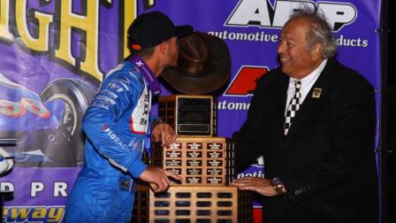 Kyle Larson (left) kisses the Aggie Hat trophy as J.C. Agajanian Jr. (right) looks on after Larson captured Saturday night's 82nd running of the ARP Turkey Night Grand Prix Presented by the West Coast Stock Car/Motorsports Hall of Fame at California's Ventura Raceway. (Rich Forman Photo) (Video Highlights from FloRacing.com)