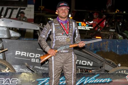 Tyler Courtney celebrates in victory lane with the "Tony Hulman Classic" rifle after winning Wednesday night's USAC AMSOIL National Sprint Car feature at the Terre Haute (Ind.) Action Track (Dallas Breeze Photo)